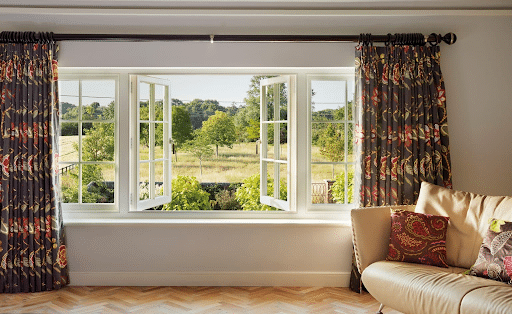 A luxury glass French window showcasing an obstructed view of nature during the day.